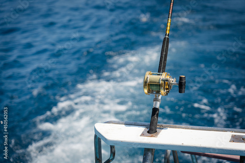 Fishing trolling tuna with speedboat on the pacific ocean. Blue sky and blue water.fishing rod outdoor catching fish at sunny day.