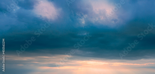 Panorama of stormy sky before sunset. Dark clouds in the sunset sky. © Andrii Chagovets