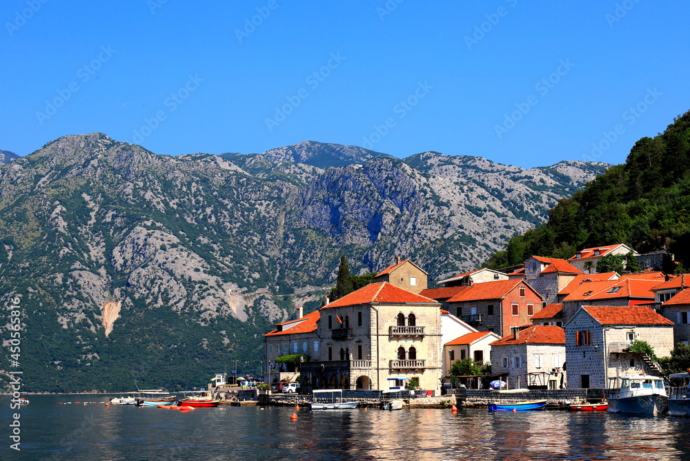 Old Historic buildings in Perast, Montenegro. A beautiful town in Kotor Bay in summer near high mountains. Adriatic Sea, Montenegro