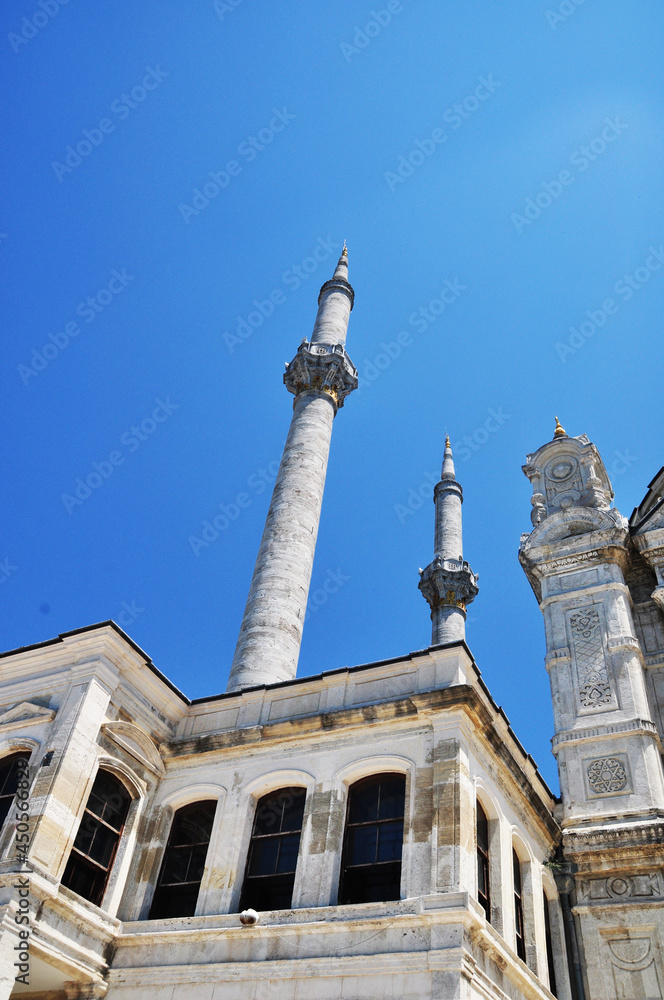 Fototapeta premium View of two minarets and a mosque. High minarets against the blue sky. Old mosque in Istanbul.