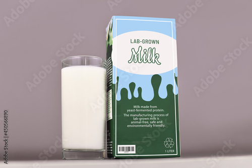 Concept for lab grown milk from artificial cultured dairy production fby using reproduced milk proteins. Carton with made up label and drinking glass photo