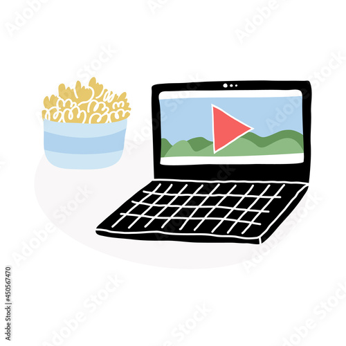 A perfect match, a laptop with a paused movie plus homemade popcorn in the bowl. Watching TV show, serial at home. 