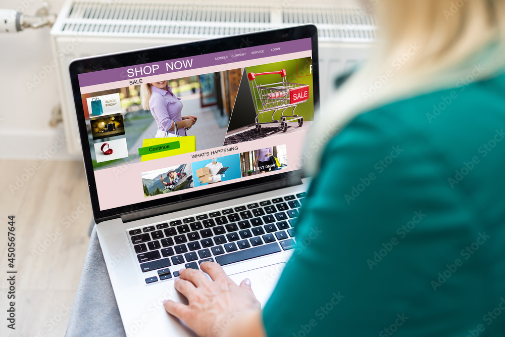 Woman shopping online using her laptop at home Woman shopping online using her laptop at home