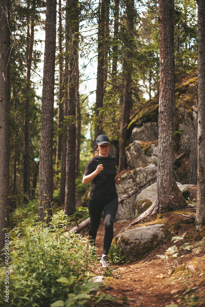 Cross-country running in the forest. A woman goes in for sports in nature, challenge herself. Cross-country running in the forest. A woman goes in for sports in nature, challenge herself.