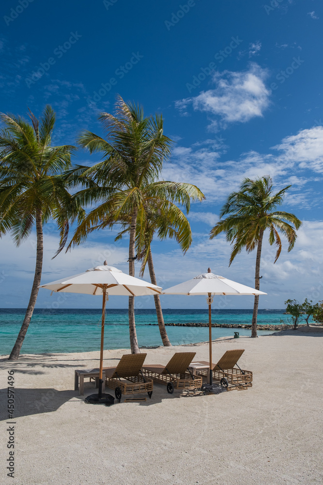 Beautiful landscape with sunbeds and umbrellas on the sandy beach, Maldives island. Crossroads Maldives, saii lagoon. July 2021