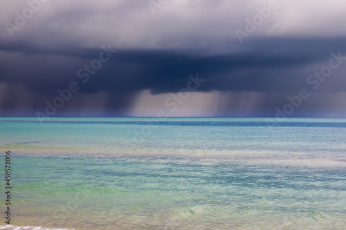 Heavy leaden clouds with rain over the blue sea. Typhoon over the Black Sea.