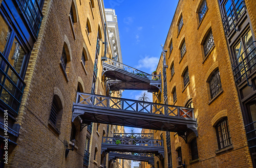 Shad Thames in London, UK. Historic Shad Thames is an old cobbled street known for it's restored overhead bridges and walkways. This old street is in Bermondsey near Tower Bridge and London Bridge.