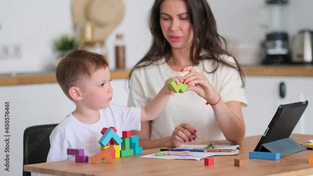 Mother with young boy using digital tablet.happy mom and baby play educational online games on the tablet Mother with young boy using digital tablet.happy mom and baby play educational online games on the tablet