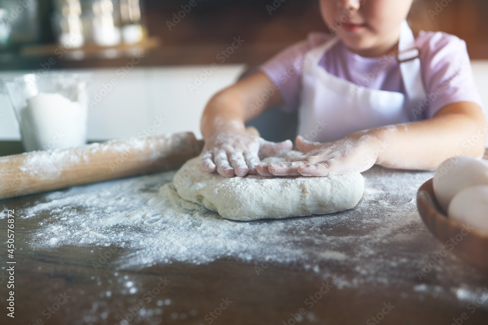 Sweet little cute girl is learning how to make a cake, in the home kitchen, Family concept, Vintage color tone. Top view