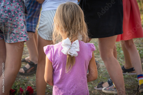Children turned away from the child (girl), do not want to play and be friends with the child.
