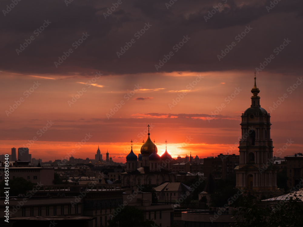 Silhouettes of the church highlighted by red sunset