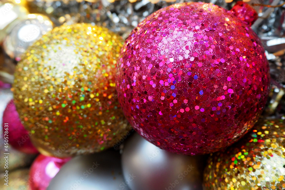 Obraz premium big shiny round gold and pink Christmas toys are hanging on the Christmas tree. side view