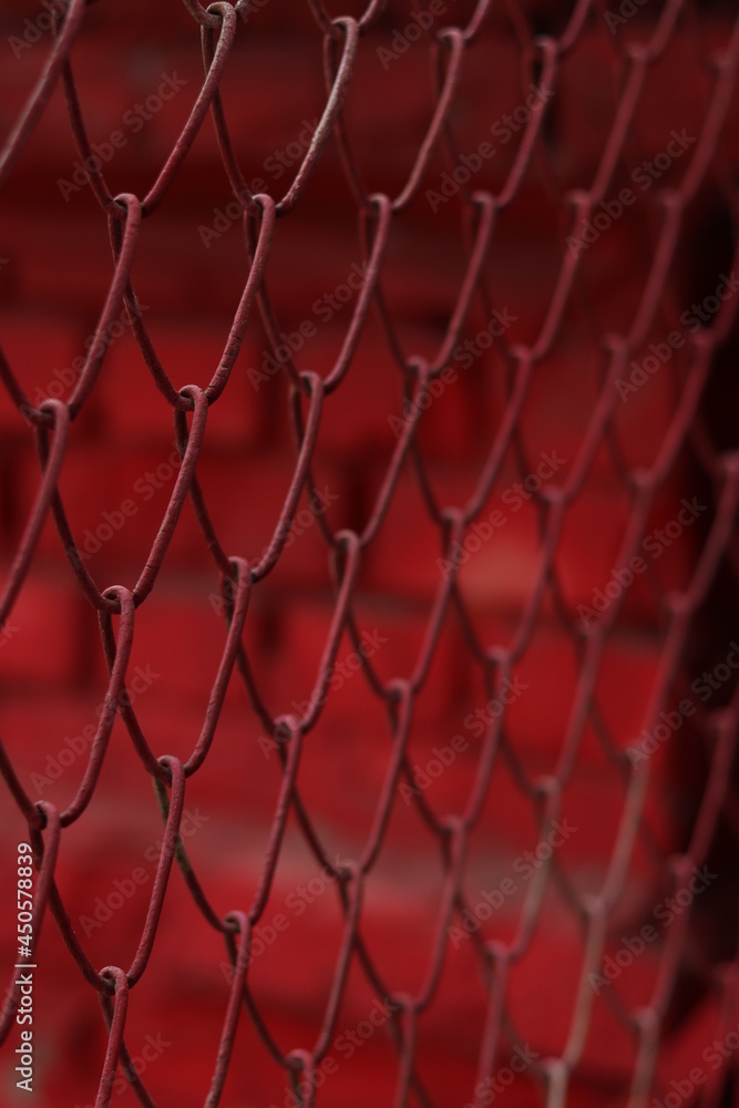 Fototapeta premium red metal mesh fence