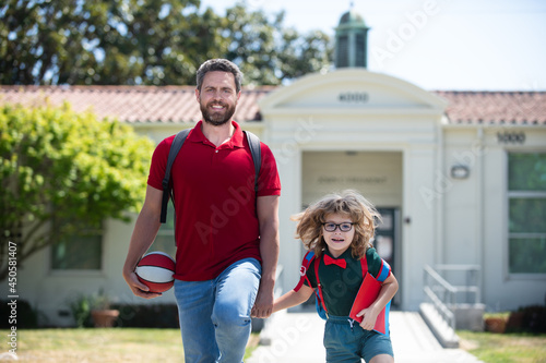 Dad and child go hand in hand. Beginning of lessons. Teachers day. School boy going to school with father. Back to school and happy time. © Volodymyr