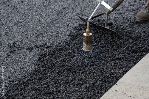 Paving the road over a bridge with porous asphalt for traffic noise reduction in Geneva, switzerland.