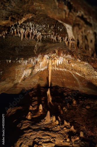 Koneprusy, Czech Republic, 24 July 2021: Natural dripstone rock formations with stone decoration in Koneprusy limestone caves in Bohemian Karst, underground world with stalagmite and stalactite halls photo