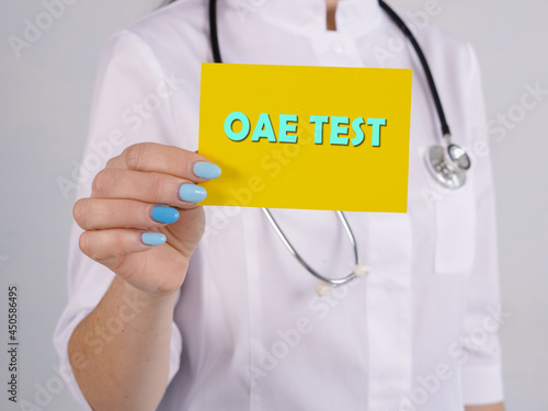 Medical concept meaning Otoacoustic Emissions OAE TEST with sign on the piece of paper. photo