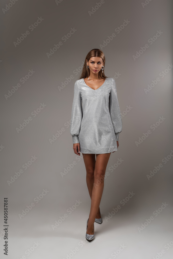 Elegant stunning model in grey dress and heels. Elegant stunning model in grey dress and heels.