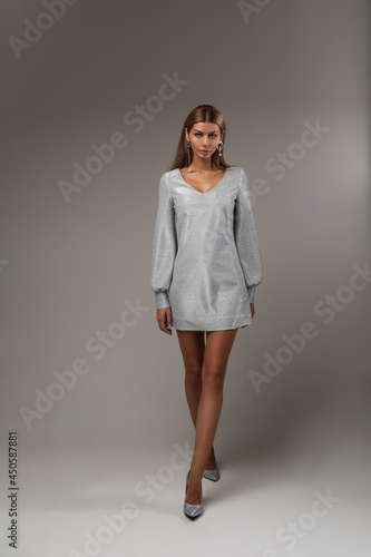 Elegant stunning model in grey dress and heels. © Вячеслав Косько