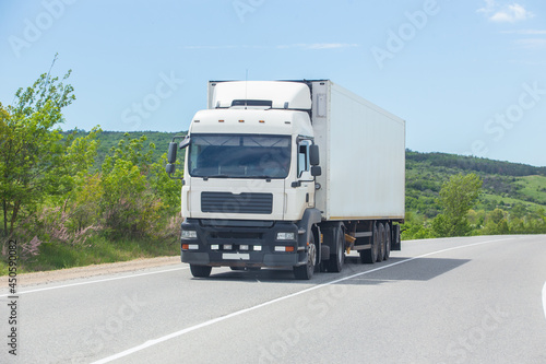 Truck moves along a suburban highway © Yuri Bizgaimer