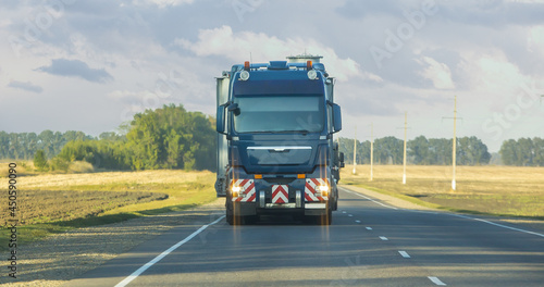 Truck is moving along a country road.