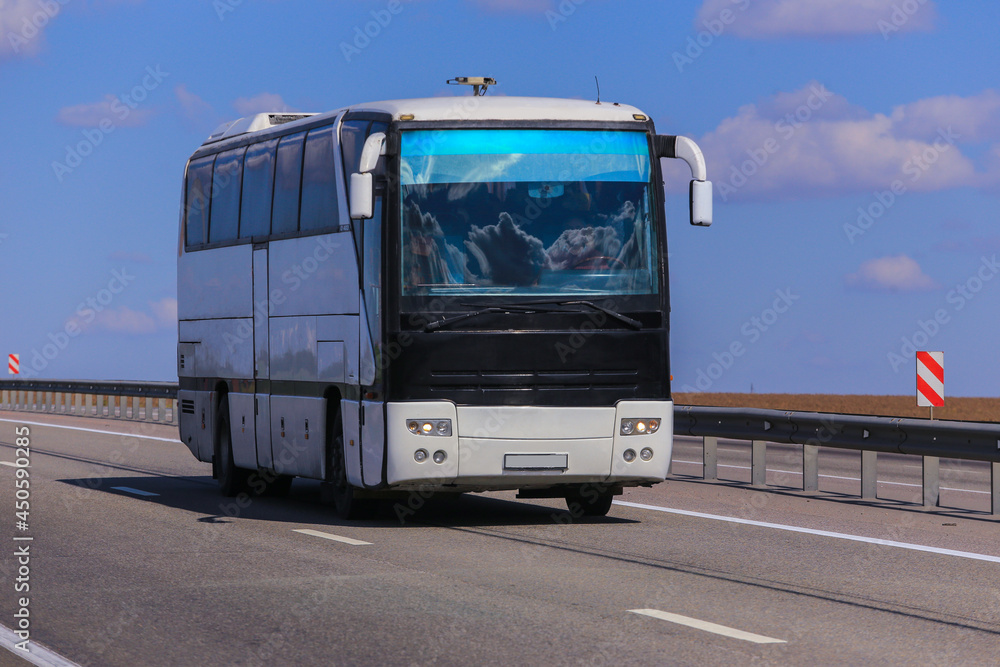 Tourist Bus Moves along the Country Highway