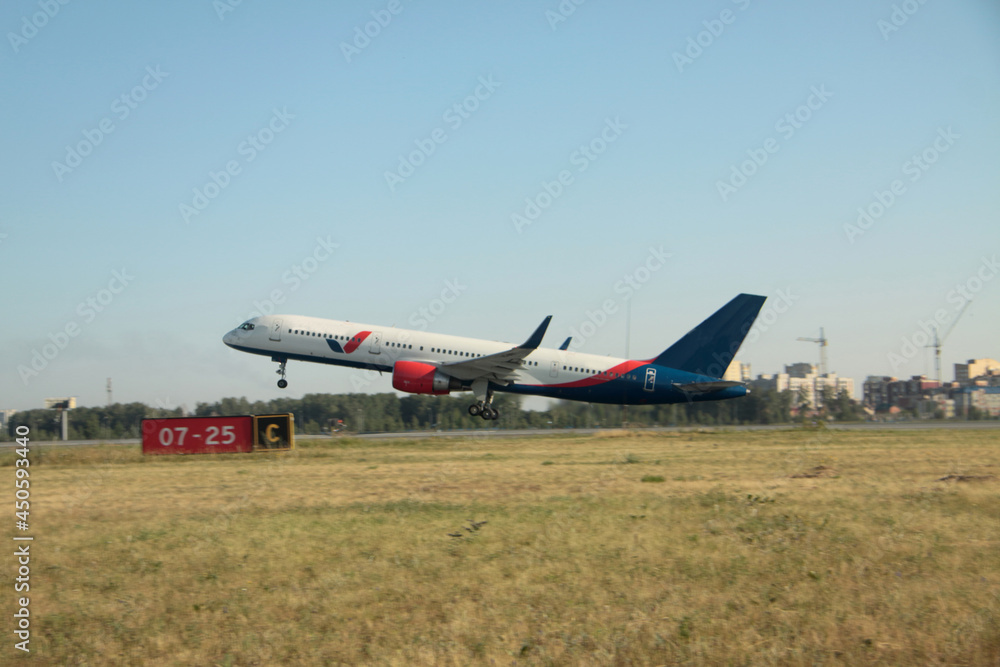 Passenger plane takes off from the airport runway Passenger plane takes off from the airport runway