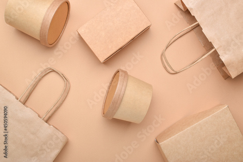 Paper packaging on a beige background. Food delivery, takeaway food. Environmental protection. Zero waste.
