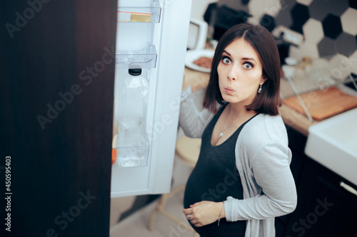 Hungry Pregnant Woman Checking the Fridge for Food