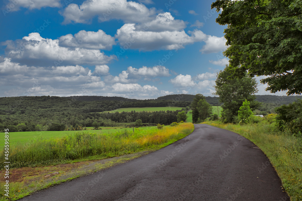 Cloudy skies over a lonely country road somewhere in the Catskills region in upstate, New York