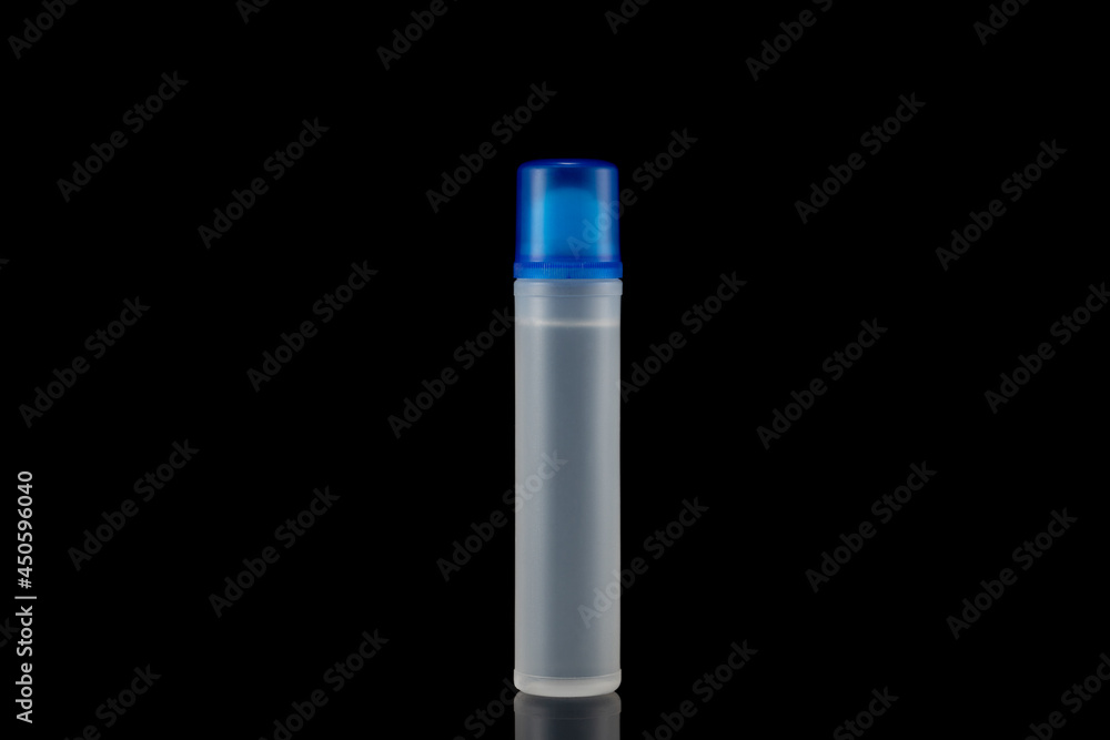 Plastic bottle of liquid paper glue, on a black background. Plastic bottle of liquid paper glue, on a black background.