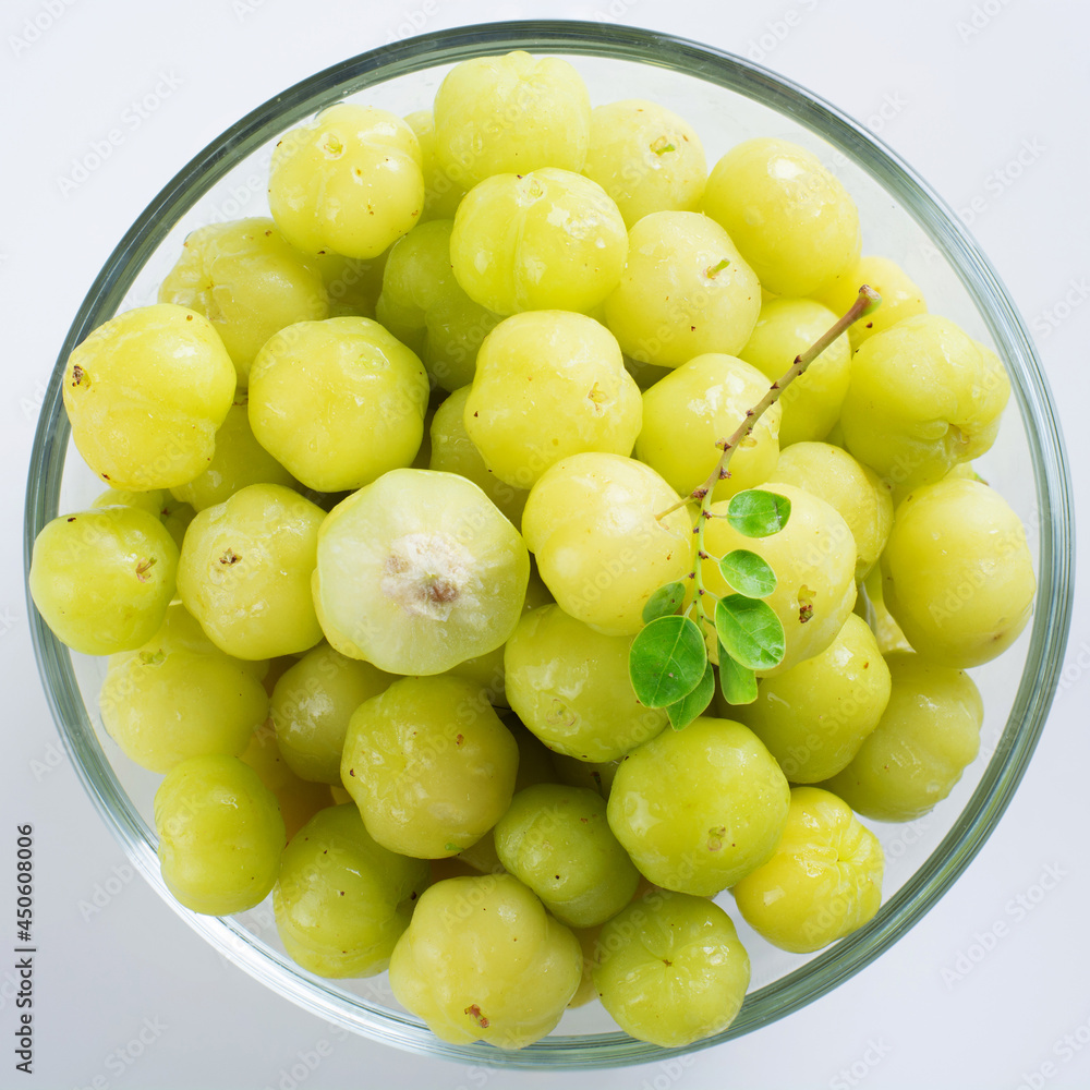 Gooseberry in a glass cup on a white background Gooseberry in a glass cup on a white background