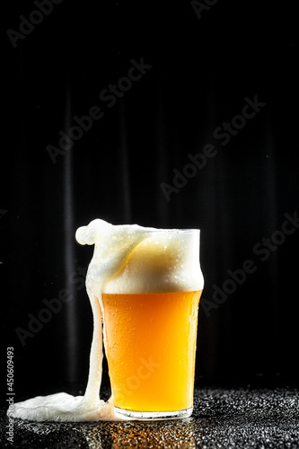 Frosty glass of light beer, craft beer with thick foam, vertical image. place for text