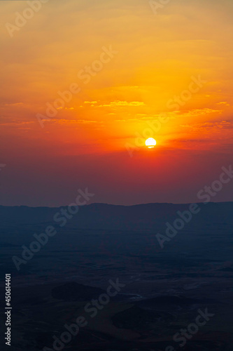 Sunrise at Makhtesh Ramon Israel. The sun is in the clouds.