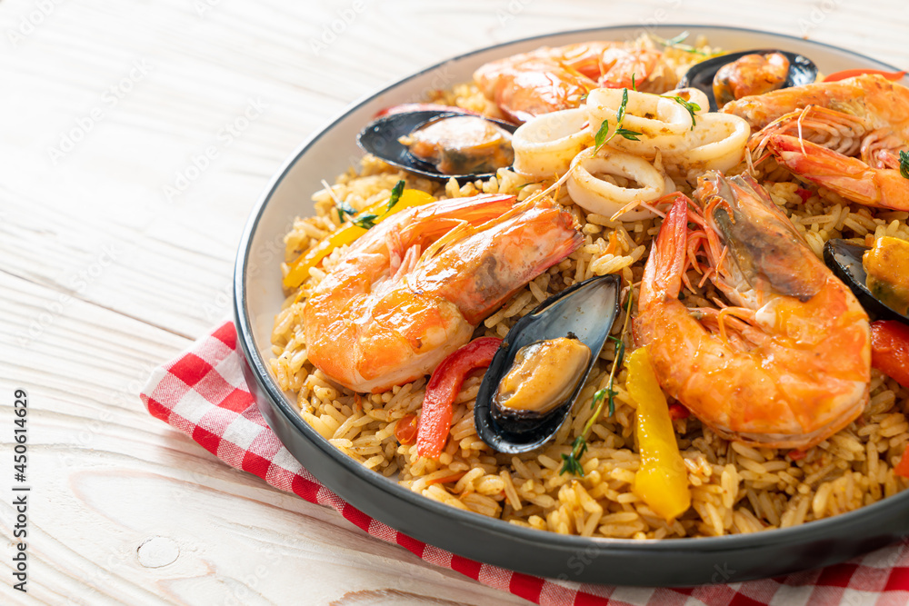 Seafood Paella with prawns, clams, mussels on saffron rice Seafood Paella with prawns, clams, mussels on saffron rice