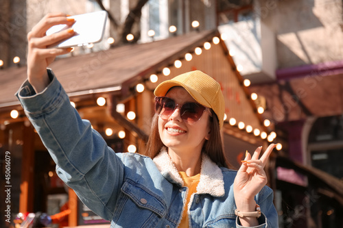 Beautiful young woman takin...