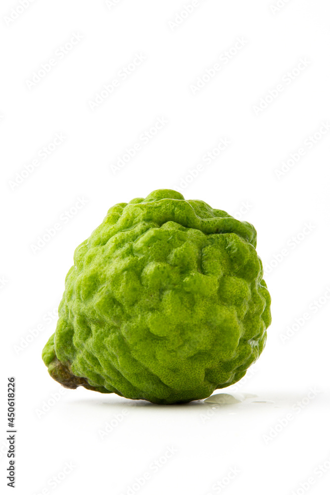 1 bergamot isolated on a white background, There are many names such as Kaffir lime, Leech lime and Mauritius papeda. it's green, rough, sour and aroma. Herbs for cooking and medicine. 1 bergamot isolated on a white background, There are many names such as Kaffir lime, Leech lime and Mauritius papeda. it's green, rough, sour and aroma. Herbs for cooking and medicine.