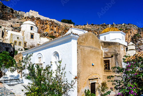 Fototapeta Naklejka Na Ścianę i Meble -  View on Monemvasia street panorama with old houses, trees in ancient town, Peloponnese, Greece