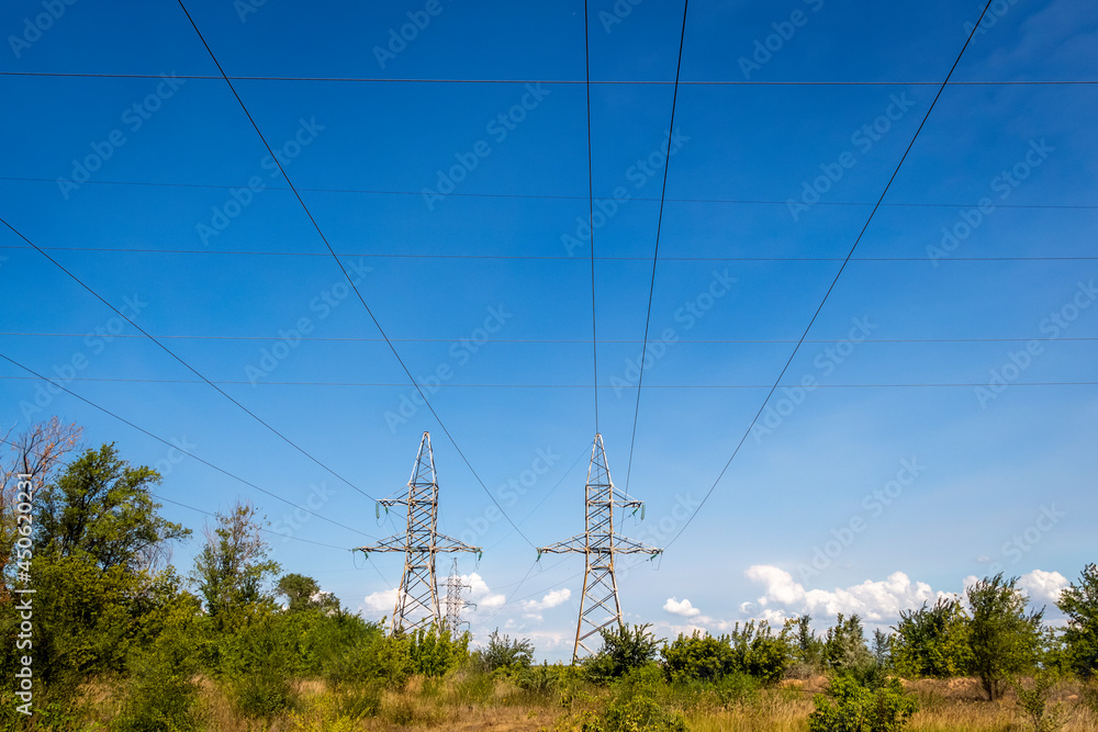 High voltage electrical lines and equipment against the blue sky.