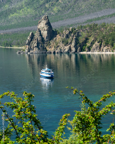 Tourist ship on Lake Baikal near the Malaya Bell Tower rock photo