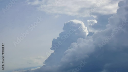 Massive rain clouds, cumulus congestus or towering cumulus, rise high into the sky