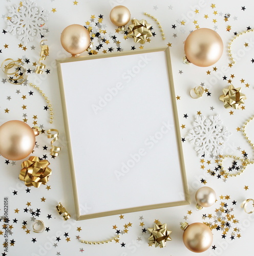 Gold frame mockup blank paper and Christmas decoration top view with copy spa...