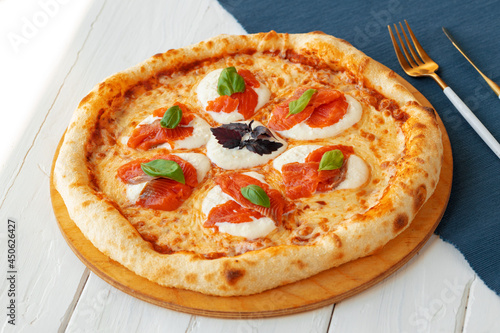Hot pizza Margherita on white wooden table