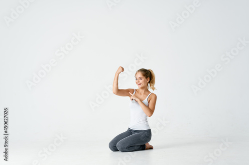 woman with dumbbells in her hands sitting on the floor exercise gym
