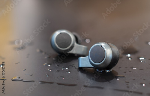 The True Wireless Water Proof Earphone on the black table with sweat or water after finish exercise sport activity