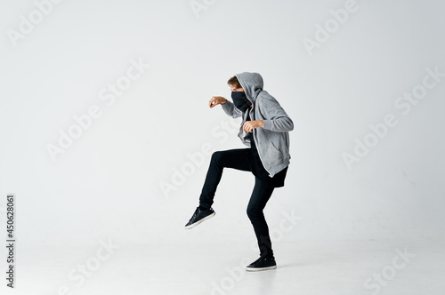 Tablou pe pânză man hiding face in mask hooded sneaking stealing isolated background