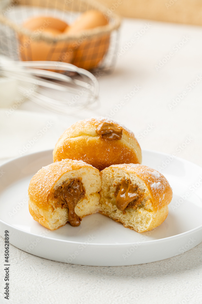 A bombolone or bomboloni is an Italian filled doughnut and is eaten as a snack food and dessert. This Bomboloni has many flavors like strawberry, chocolate, blueberry, etc. A bombolone or bomboloni is an Italian filled doughnut and is eaten as a snack food and dessert. This Bomboloni has many flavors like strawberry, chocolate, blueberry, etc.