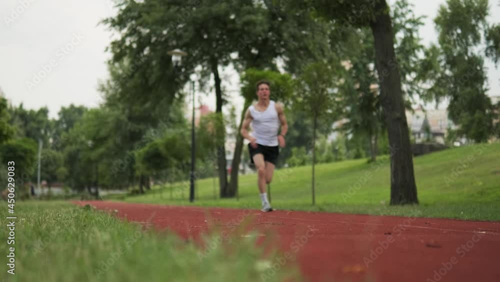 An athlete guy is running a marathon at playground outdoors An athlete guy is running a marathon at playground outdoors