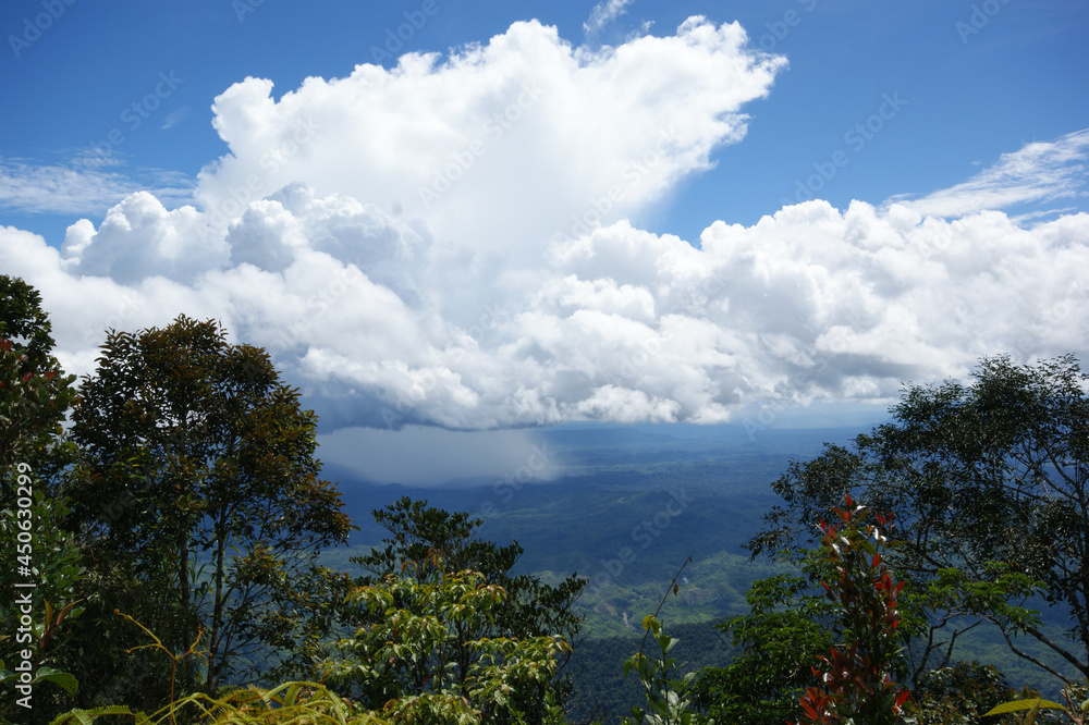 Rain falling from clouds over Kalimantan, view from Mount Penrissen, Sarawak, Borneo, Malaysia