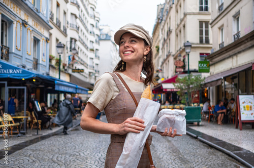 Attractive girl with French baguette on the street photo